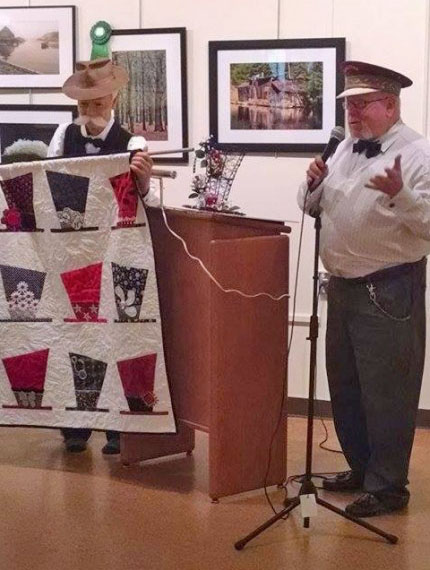 Director Gary Parks welcoming the group and showing the quilt and centerpeice that was up for raffle! 